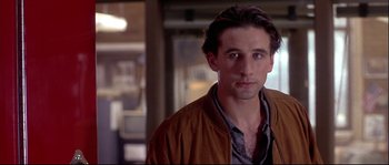 Movie still from “Backdraft” (1991), directed by Ron Howard – A person wearing a brown jacket; Close Up shot, Over the shoulder angle