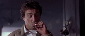 Movie still from “Backdraft” (1991), directed by Ron Howard – A person smoking a cigarette; Close Up shot, Low angle