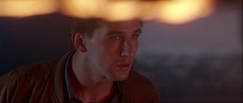 Movie still from “Backdraft” (1991), directed by Ron Howard – A man's face in the light; Close Up shot, Low angle