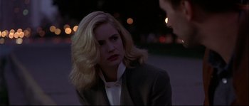 Movie still from “Backdraft” (1991), directed by Ron Howard – A woman with blonde hair is sitting outside; Close Up shot, Over the shoulder angle