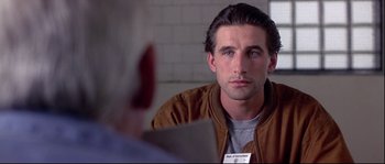 Movie still from “Backdraft” (1991), directed by Ron Howard – A young man looking into a mirror while wearing a name tag; Close Up shot, Over the shoulder angle