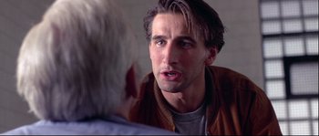 Movie still from “Backdraft” (1991), directed by Ron Howard – A man talking to another man in front of a mirror; Close Up shot, Over the shoulder angle