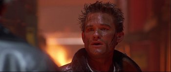 Movie still from “Backdraft” (1991), directed by Ron Howard – A person wearing a leather jacket; Close Up shot, Low angle