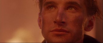 Movie still from “Backdraft” (1991), directed by Ron Howard – A man's face with water droplets on his face; Extreme Close Up shot, Low angle