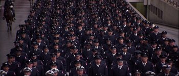 Movie still from “Backdraft” (1991), directed by Ron Howard – A large group of men in uniform standing together; Wide shot, High angle