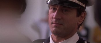 Movie still from “Backdraft” (1991), directed by Ron Howard – A person wearing a hat; Close Up shot, Low angle
