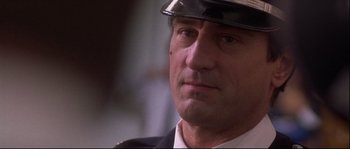 Movie still from “Backdraft” (1991), directed by Ron Howard – A person wearing a hat; Close Up shot, Low angle