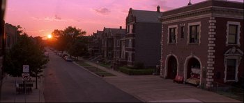 Movie still from “Backdraft” (1991), directed by Ron Howard – A row of houses on a residential street at sunset; Extreme Wide shot, High angle