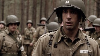 Movie still from “Band of Brothers” (2001), directed by David Frankel – A group of men in military fatigues and helmets; Close Up shot, Over the shoulder angle
