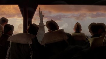 Movie still from “Band of Brothers” (2001), directed by David Frankel – A group of men sitting in front of the statue of liberty; Wide shot, Low angle