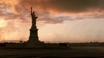 Movie still from “Band of Brothers” (2001), directed by David Frankel – The statue of liberty is silhouetted against a cloudy sky; Extreme Wide shot, Low angle