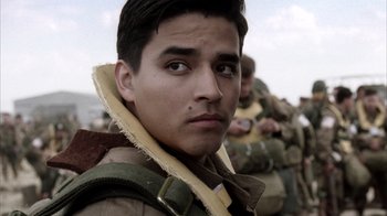 Movie still from “Band of Brothers” (2001), directed by David Frankel – A young man in a military uniform looking at the camera; Close Up shot, Over the shoulder angle
