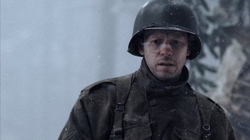 Movie still from “Band of Brothers” (2001), directed by David Frankel – A man in a military uniform wearing a helmet; Close Up shot, High angle