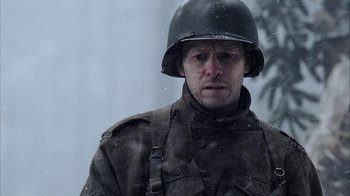 Movie still from “Band of Brothers” (2001), directed by David Frankel – A man in a military uniform wearing a helmet; Close Up shot, Low angle
