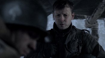 Movie still from “Band of Brothers” (2001), directed by David Frankel – A person wearing a jacket; Close Up shot, Over the shoulder angle