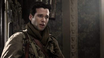 Movie still from “Band of Brothers” (2001), directed by David Frankel – A man wearing a scarf and a military jacket; Close Up shot, Over the shoulder angle