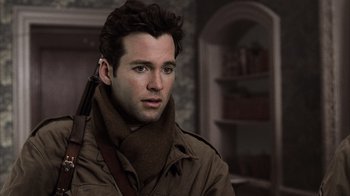 Movie still from “Band of Brothers” (2001), directed by David Frankel – A person wearing a scarf; Close Up shot, Over the shoulder angle