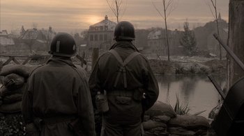 Movie still from “Band of Brothers” (2001), directed by David Frankel – Two men in military uniforms looking out over a lake; Medium shot, Low angle