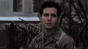 Movie still from “Band of Brothers” (2001), directed by David Frankel – A man with a gun in his hand and wearing a military uniform; Close Up shot, Low angle