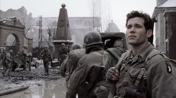 Movie still from “Band of Brothers” (2001), directed by David Frankel – A group of men in uniform walking through the rain; Close Up shot, Low angle