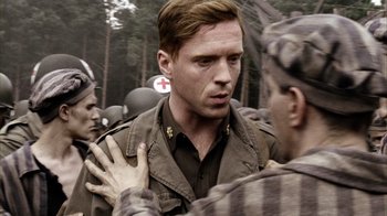 Movie still from “Band of Brothers” (2001), directed by David Frankel – A man in a military uniform talking to another man in fatigues; Close Up shot, Over the shoulder angle