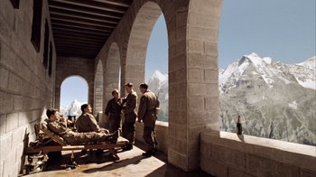 Movie still from “Band of Brothers” (2001), directed by David Frankel – A group of men standing on top of a stone building; Wide shot, High angle