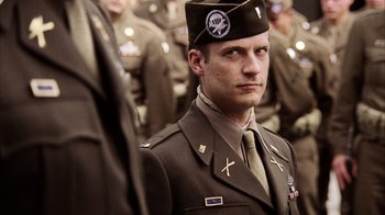 Movie still from “Band of Brothers” (2001), directed by David Frankel – A man in a military uniform with a hat on; Close Up shot, Low angle