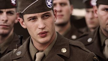 Movie still from “Band of Brothers” (2001), directed by David Frankel – A person wearing a uniform; Close Up shot, Over the shoulder angle