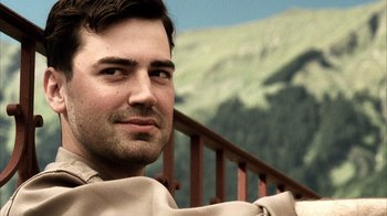 Movie still from “Band of Brothers” (2001), directed by David Frankel – A person with a mountain in the background; Close Up shot, Over the shoulder angle