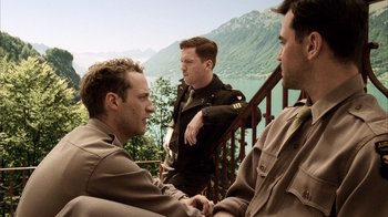 Movie still from “Band of Brothers” (2001), directed by David Frankel – A group of men standing on a deck next to a body of water; Medium shot, Low angle
