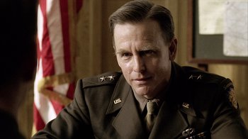 Movie still from “Band of Brothers” (2001), directed by David Frankel – A person wearing a military uniform; Close Up shot, Over the shoulder angle