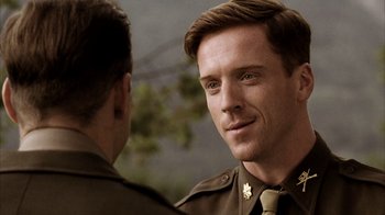 Movie still from “Band of Brothers” (2001), directed by David Frankel – A man in a military uniform talking to another man in a uniform; Close Up shot, Over the shoulder angle