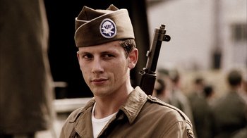 Movie still from “Band of Brothers” (2001), directed by David Frankel – A man in a military uniform holding a rifle; Close Up shot, Low angle