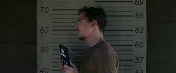 Movie still from “Band of Robbers” (2015), directed by Adam Nee – A young man holding an electronic device in his hands; Close Up shot, Low angle