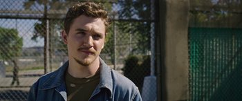 Movie still from “Band of Robbers” (2015), directed by Adam Nee – A person wearing a jacket; Close Up shot, Over the shoulder angle