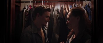 Movie still from “Band of Robbers” (2015), directed by Adam Nee – A man and a woman talking in front of clothes; Medium shot, Over the shoulder angle