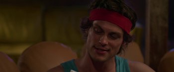 Movie still from “Band of Robbers” (2015), directed by Adam Nee – A person wearing a headband; Close Up shot, Over the shoulder angle