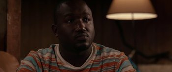 Movie still from “Band of Robbers” (2015), directed by Adam Nee – A person sitting in front of a lamp; Close Up shot, High angle