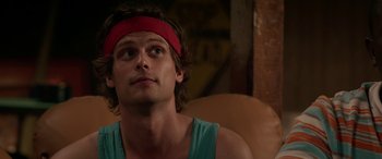 Movie still from “Band of Robbers” (2015), directed by Adam Nee – A person wearing a headband; Close Up shot, Over the shoulder angle