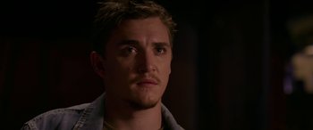 Movie still from “Band of Robbers” (2015), directed by Adam Nee – A person with a mustache; Close Up shot, Over the shoulder angle