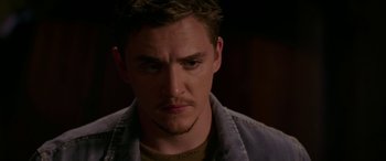 Movie still from “Band of Robbers” (2015), directed by Adam Nee – A person wearing a jean jacket; Close Up shot, Over the shoulder angle