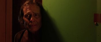 Movie still from “Band of Robbers” (2015), directed by Adam Nee – A man is leaning against a wall with his head in his hands; Close Up shot, Low angle