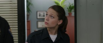 Movie still from “Band of Robbers” (2015), directed by Adam Nee – A woman in a black jacket looking up at the ceiling; Close Up shot, Over the shoulder angle