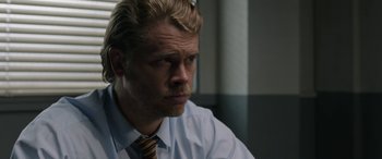 Movie still from “Band of Robbers” (2015), directed by Adam Nee – A person wearing a shirt and a tie; Close Up shot, Over the shoulder angle