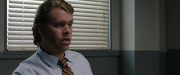 Movie still from “Band of Robbers” (2015), directed by Adam Nee – A person wearing a shirt and a tie; Close Up shot, Over the shoulder angle