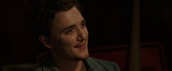 Movie still from “Band of Robbers” (2015), directed by Adam Nee – A person smiling; Close Up shot, Over the shoulder angle