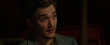 Movie still from “Band of Robbers” (2015), directed by Adam Nee – A person wearing a jean jacket; Close Up shot, Over the shoulder angle