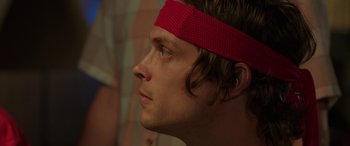 Movie still from “Band of Robbers” (2015), directed by Adam Nee – A person wearing a headband; Close Up shot, Low angle