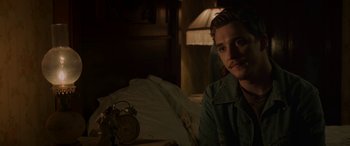 Movie still from “Band of Robbers” (2015), directed by Adam Nee – A man sitting on a bed next to an alarm clock; Close Up shot, Over the shoulder angle