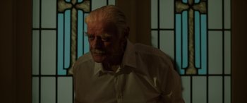 Movie still from “Band of Robbers” (2015), directed by Adam Nee – An old man with a beard and a white shirt; Close Up shot, Low angle